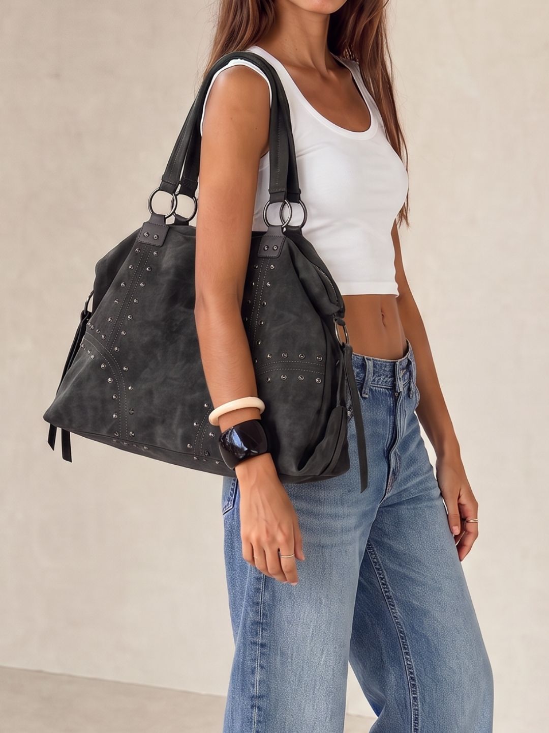 Model wearing the Le Solene black studded shoulder bag, full view