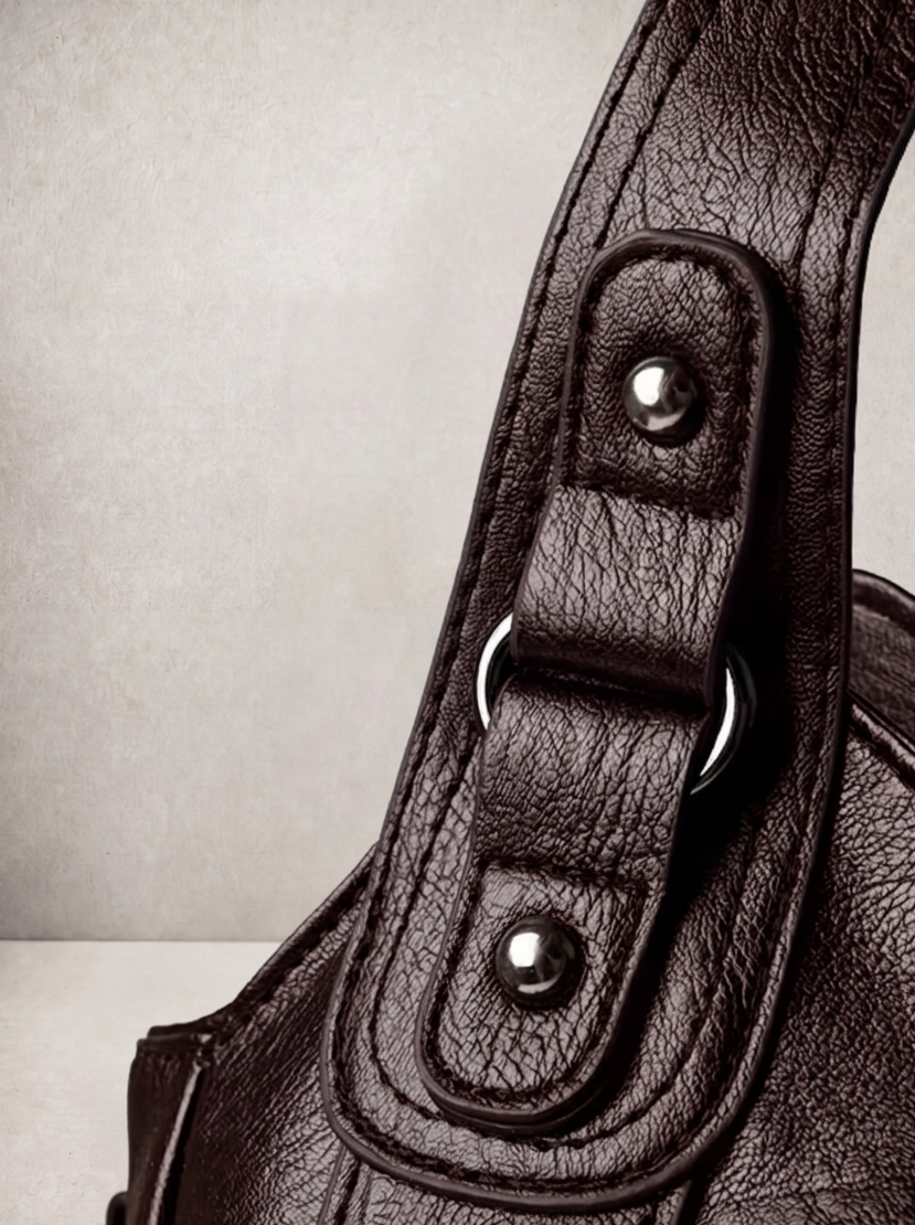 Close-up of the stud and rivet hardware on the L'Elyn coffee bag