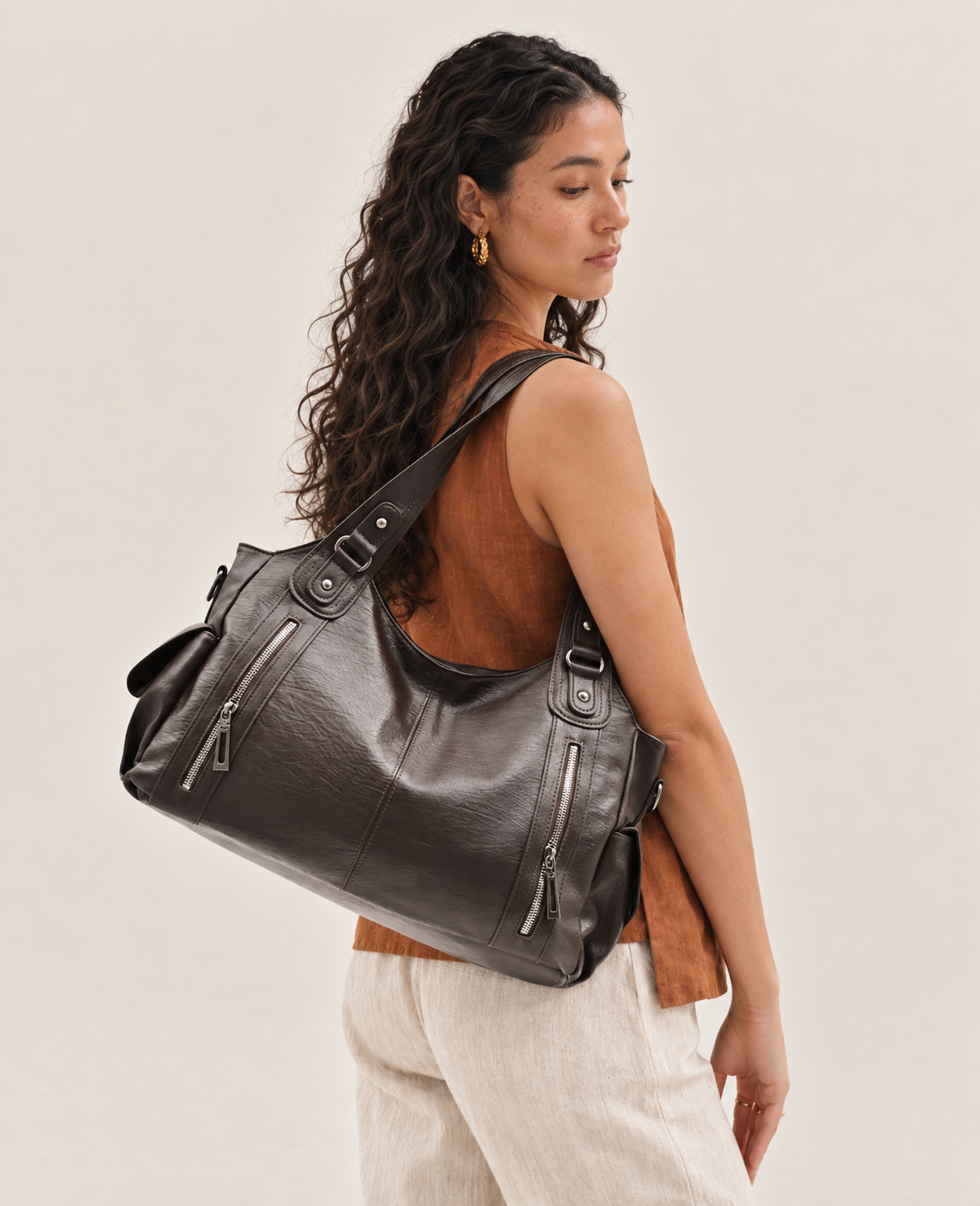 Model wearing the L'Elyn coffee vegan leather tote bag on her shoulder