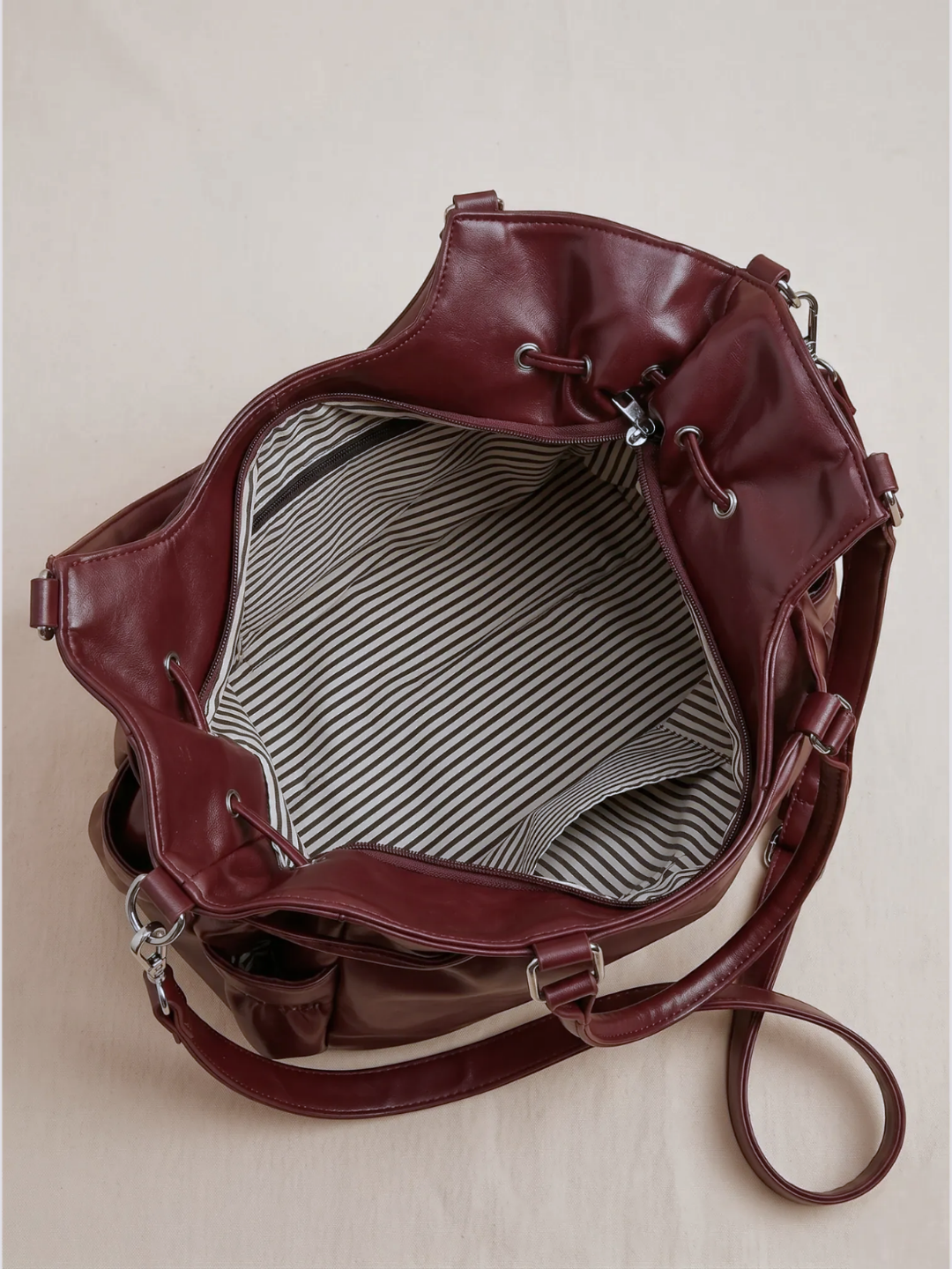 Le Nova burgundy tote bag open showing the striped interior