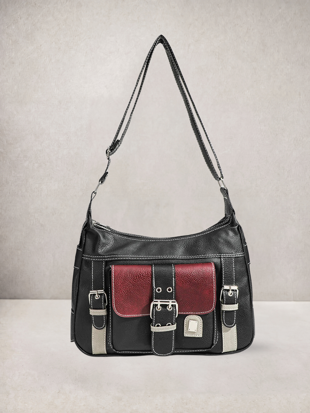 Le Chloé crossbody bag in black vegan leather with red pocket detail, three-quarter view
