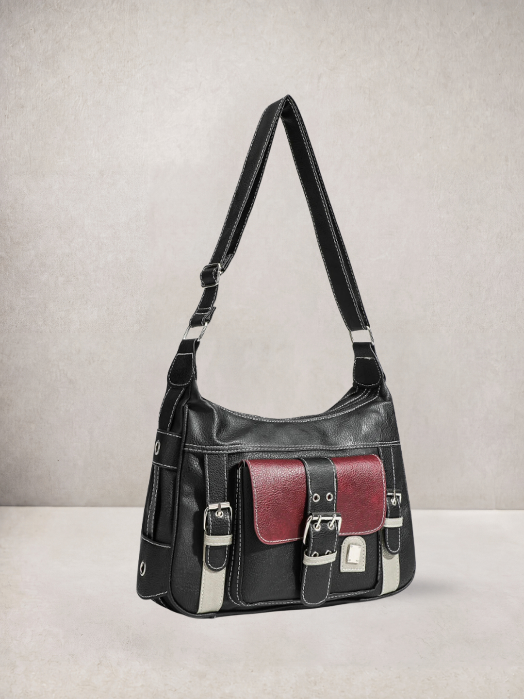 Le Chloé crossbody bag in black vegan leather, side view showing the adjustable strap