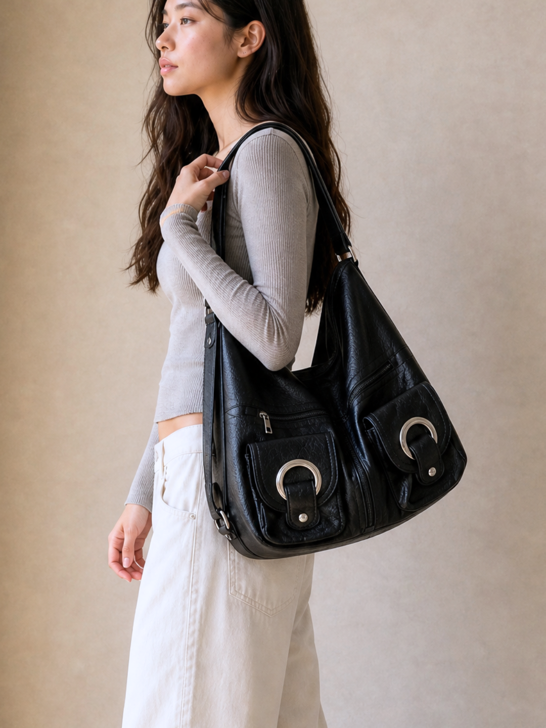 Model wearing the Le Mila black bag as a backpack, side view