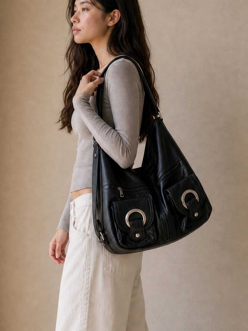 Model wearing the Le Mila black bag on her shoulder