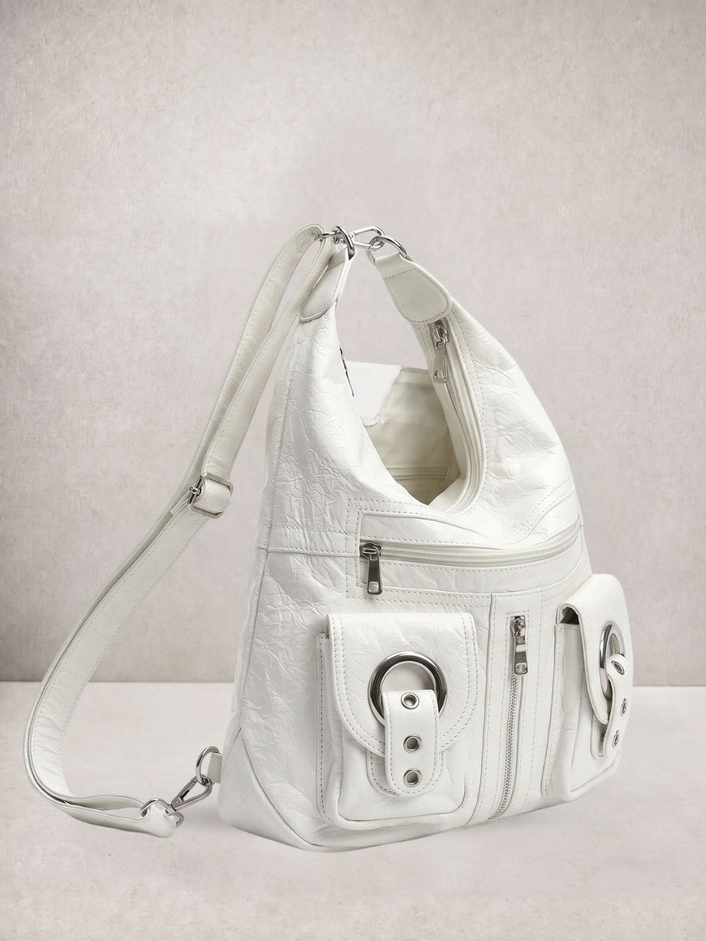 Le Mila bag in white vegan leather, front view showing round hardware details
