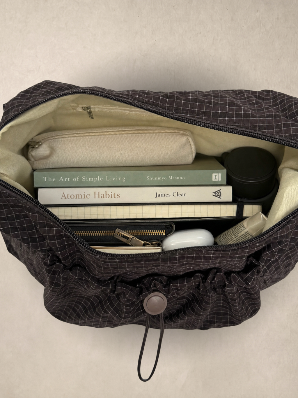 Le Rue brown hobo bag open showing the interior with everyday items