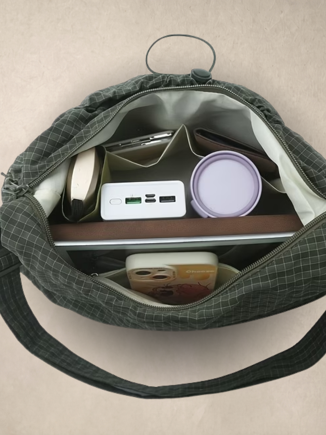 Le Rue green hobo bag open showing the interior with everyday items