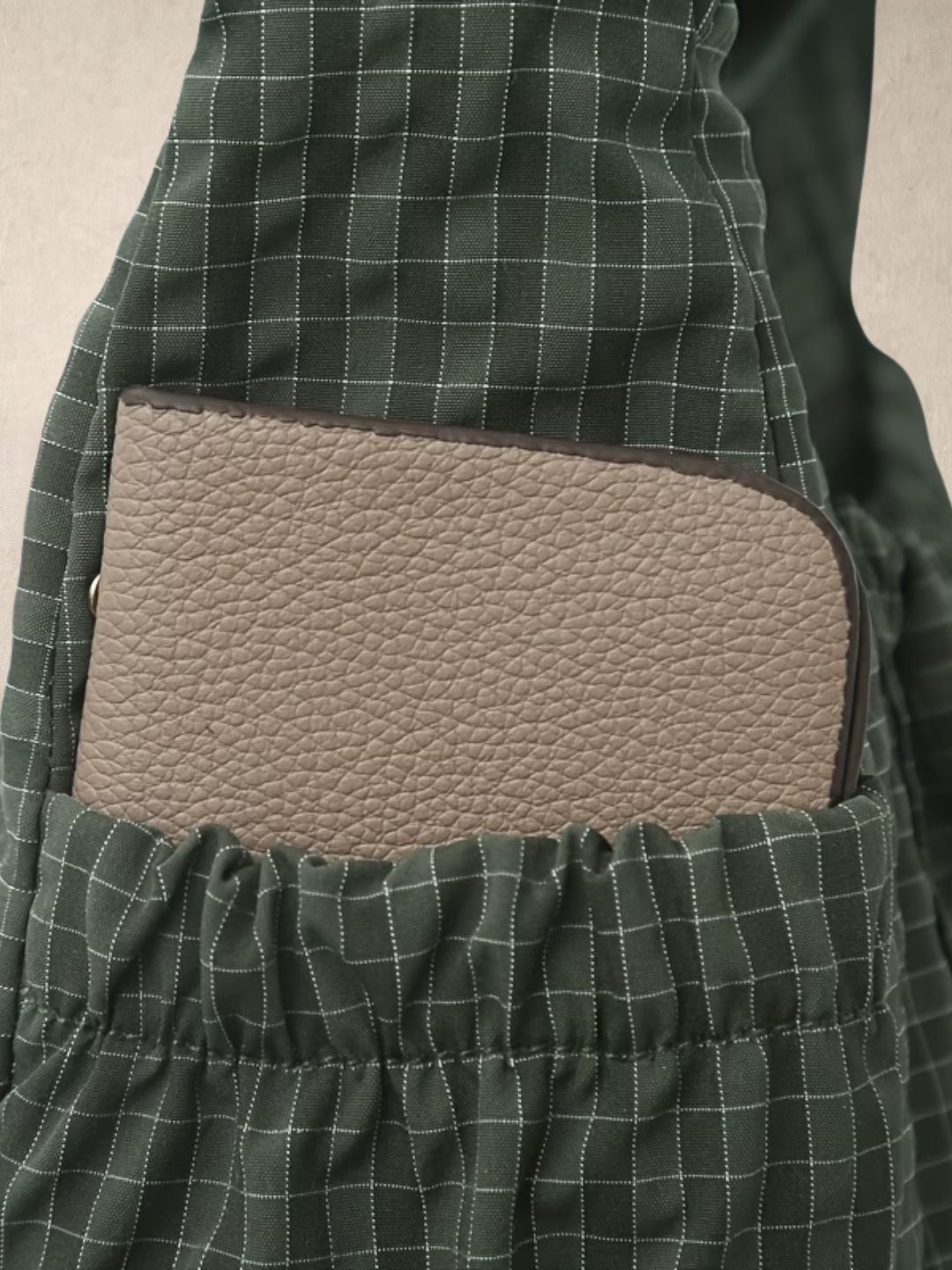 Close-up of the side pocket on the Le Rue green hobo bag