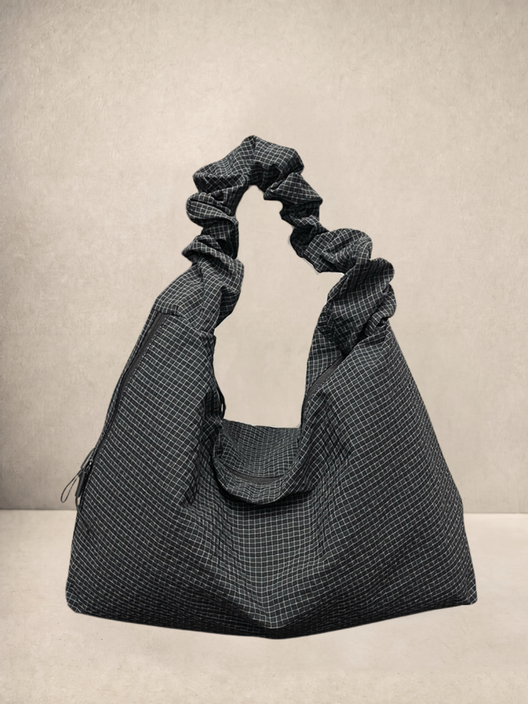 Le Scrunchie hobo bag in black checkered ripstop fabric, front view