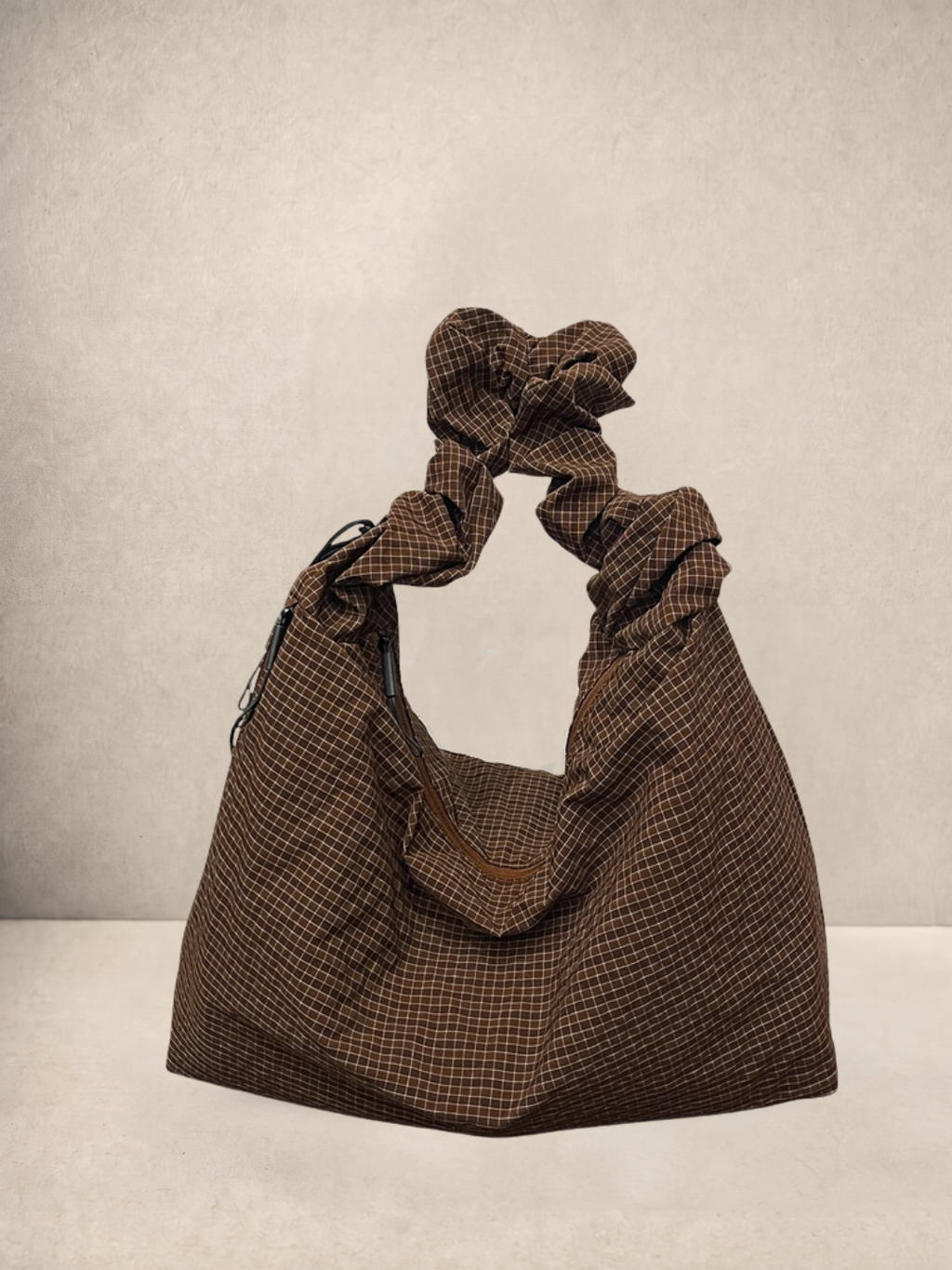 Le Scrunchie hobo bag in brown checkered ripstop fabric, front view