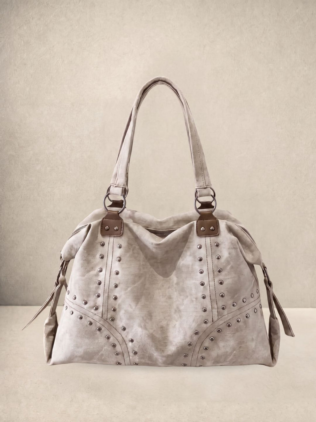Le Solene shoulder bag in white vegan leather with stud details, front view