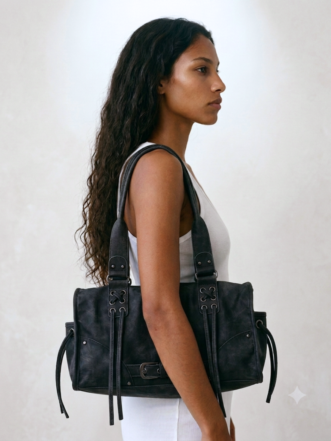 Model wearing the Le Stormie black tote bag on her shoulder, side profile