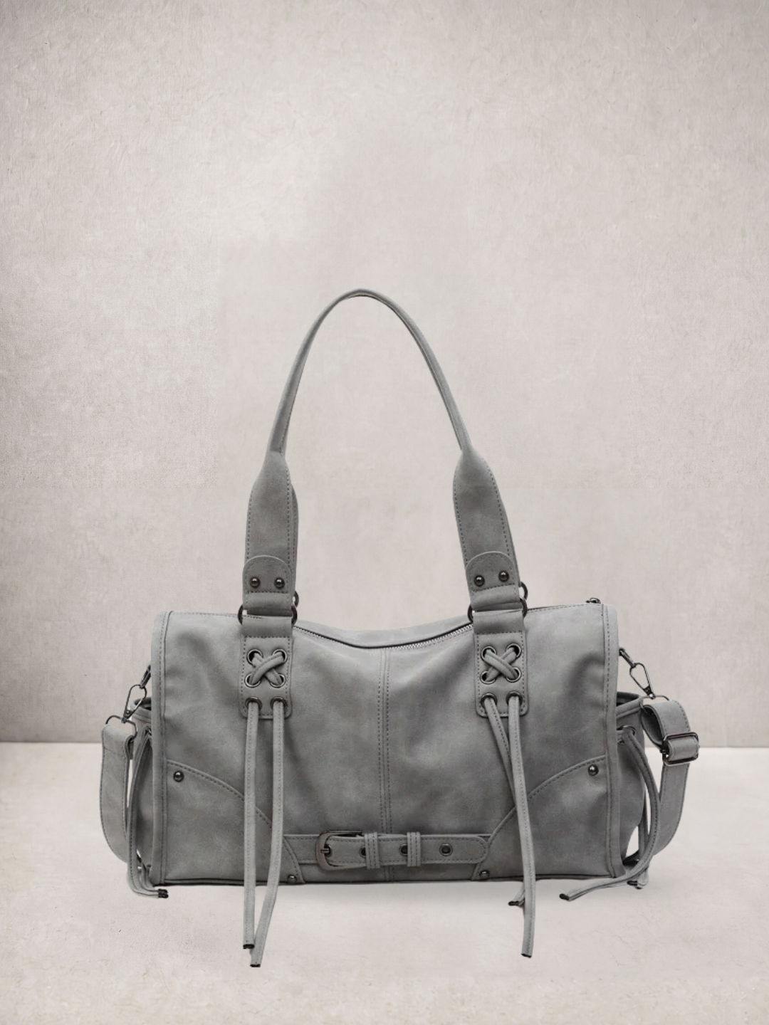 Le Stormie tote bag in grey vegan leather with fringe tassel straps, front view