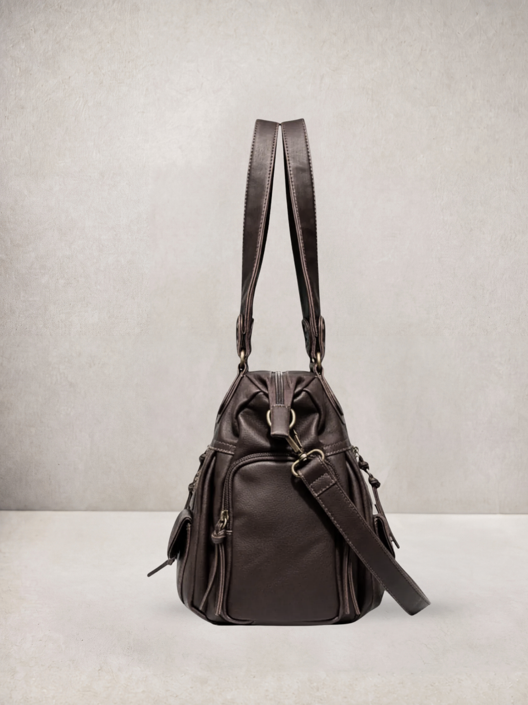 Le Vienne tote bag in dark brown vegan leather, worn as a backpack with straps up
