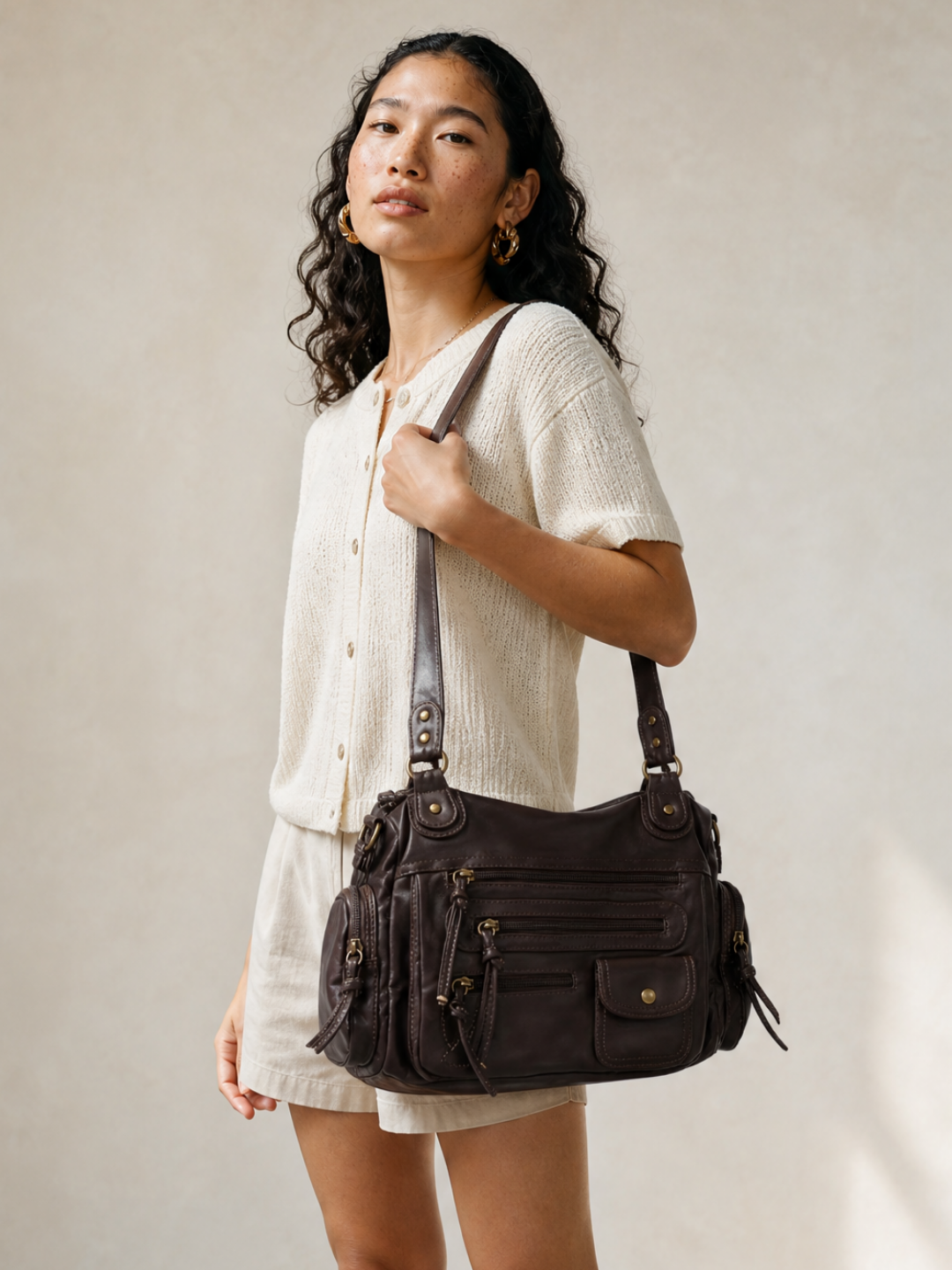 Model wearing the Le Vienne dark brown vegan leather bag on her shoulder