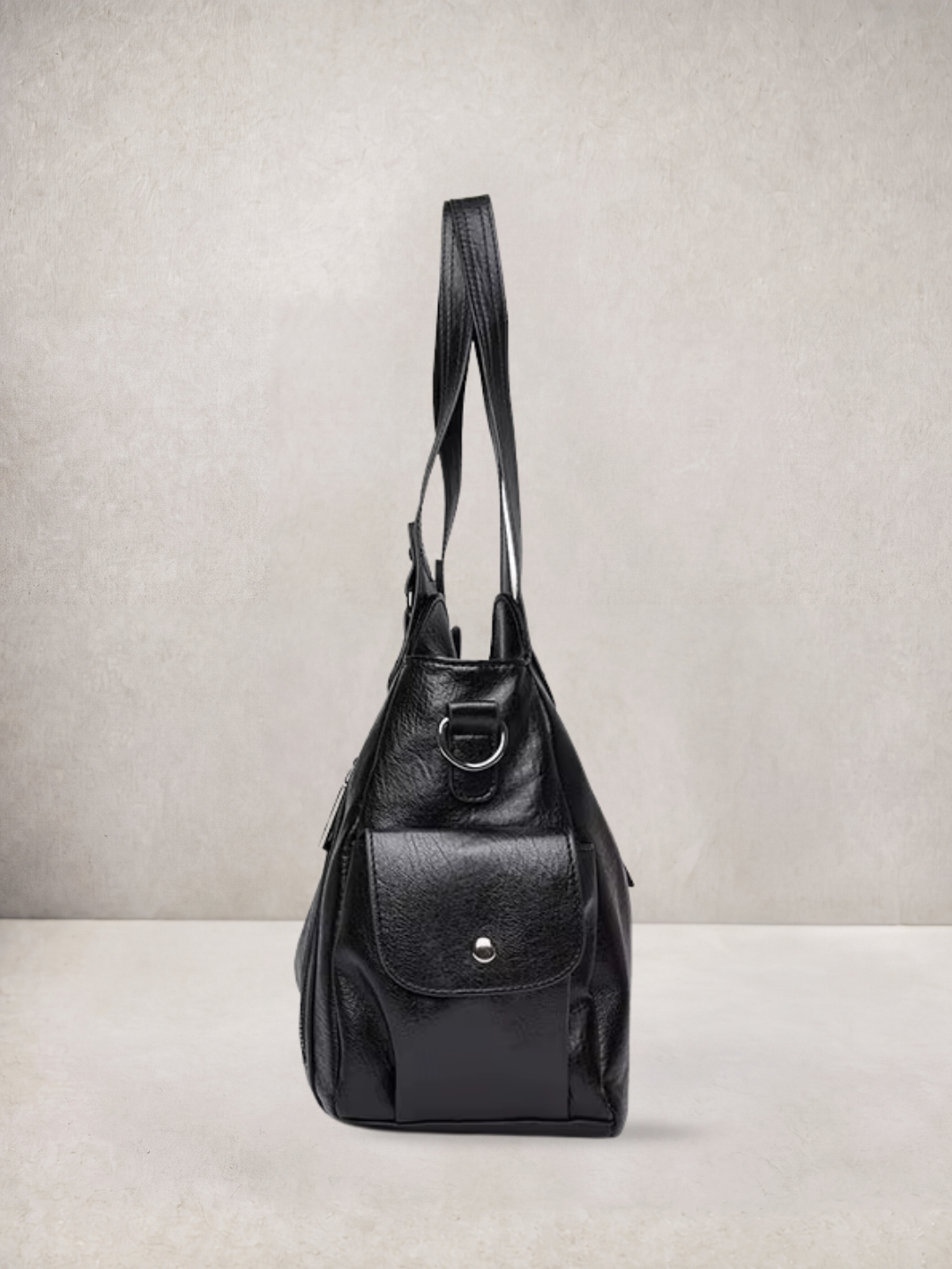 L'Elyn tote bag in black vegan leather, worn with straps up