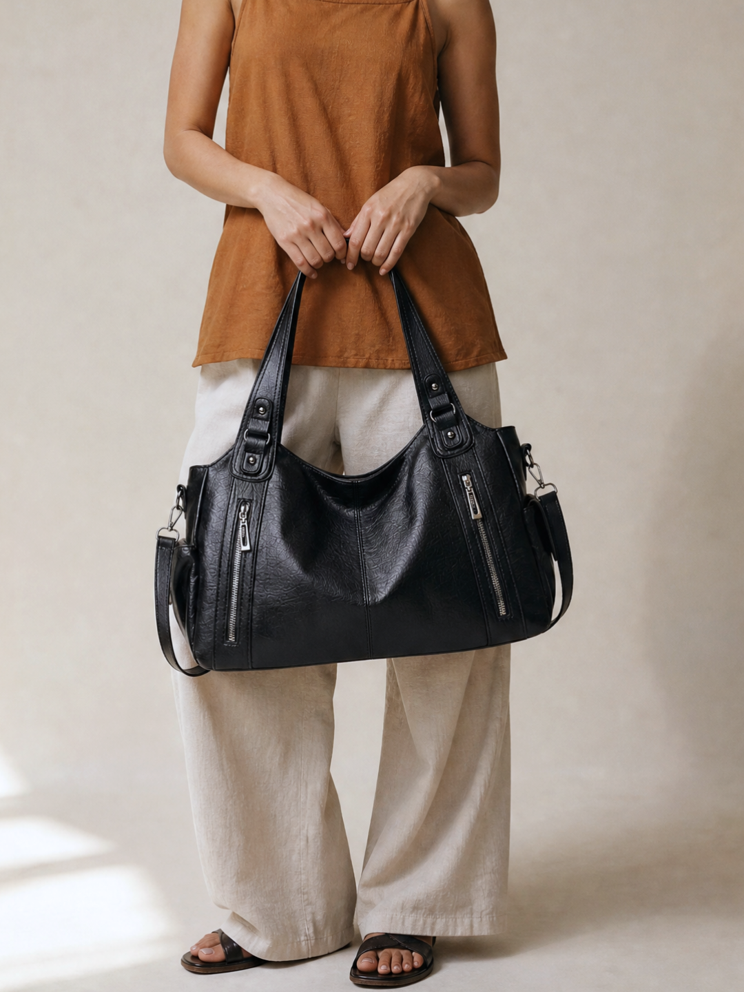Model wearing the L'Elyn black bag on her shoulder