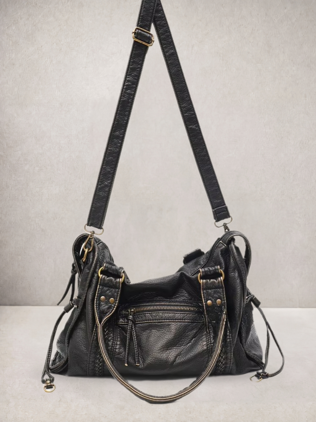 Le Rogue bag in black vegan leather, side view showing the adjustable strap