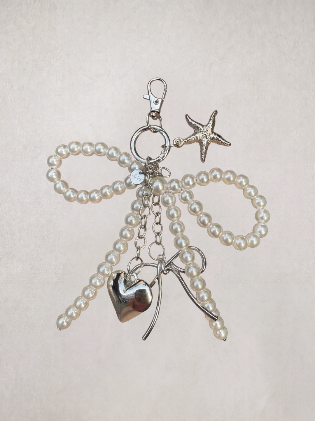 Pearl Bow Charm keychain with heart, star, and bow-shaped pearl beads, product shot